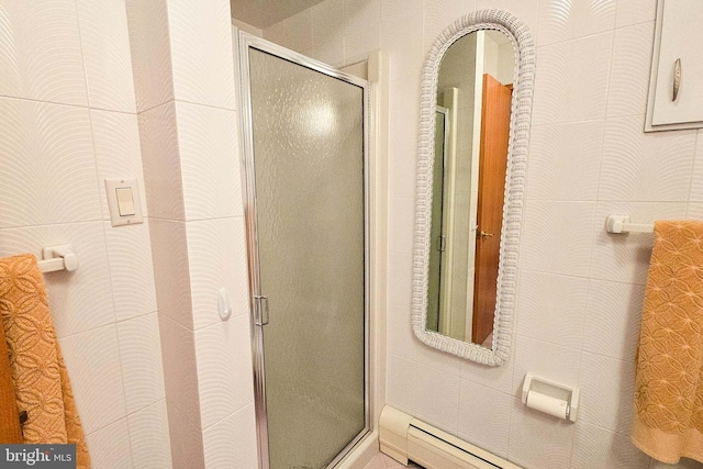 full bathroom with a baseboard heating unit and a stall shower