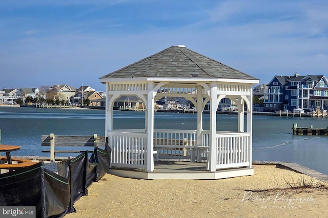 dock area featuring a gazebo, a residential view, and a water view