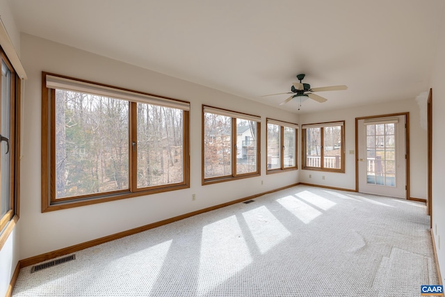 unfurnished sunroom featuring visible vents and ceiling fan