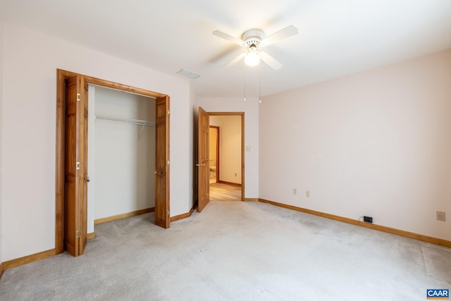 unfurnished bedroom featuring baseboards, visible vents, a closet, and light carpet