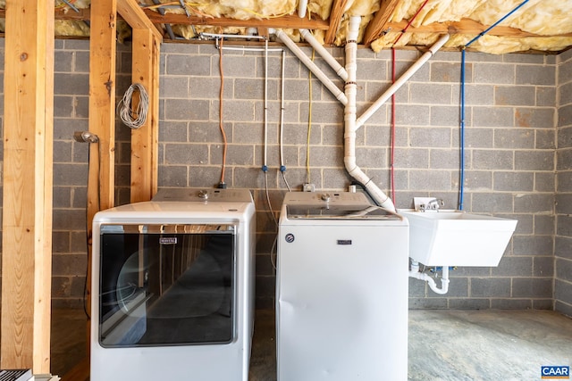 laundry room with a sink, separate washer and dryer, and laundry area