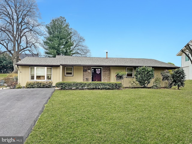 ranch-style house with a front lawn