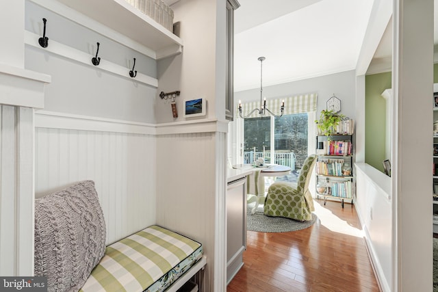 mudroom featuring crown molding, an inviting chandelier, and wood-type flooring