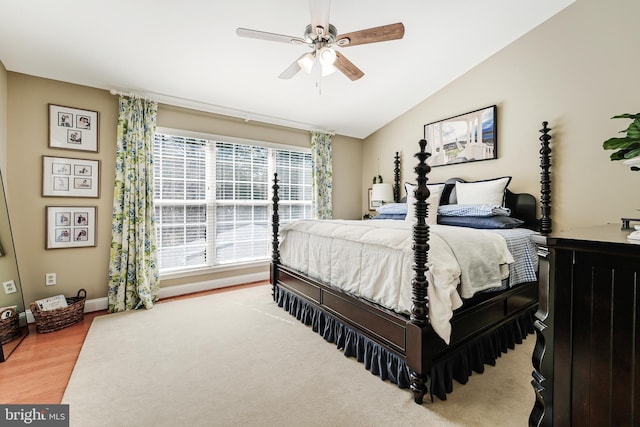 bedroom with baseboards, a ceiling fan, lofted ceiling, and wood finished floors