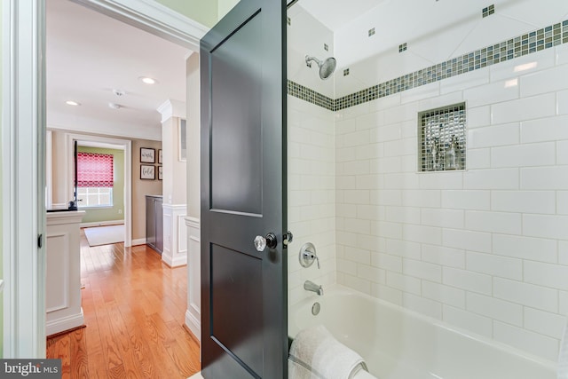 bathroom featuring visible vents, wood finished floors, and bathtub / shower combination