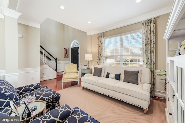 living room featuring ornamental molding, wood finished floors, recessed lighting, wainscoting, and stairs