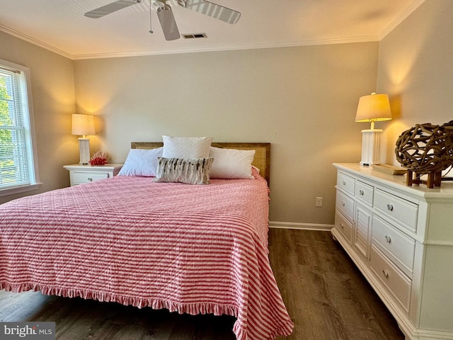 bedroom with visible vents, crown molding, baseboards, dark wood finished floors, and a ceiling fan