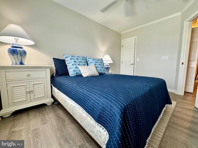 bedroom with ceiling fan, wood finished floors, baseboards, and ornamental molding