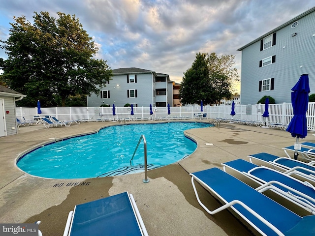 pool featuring a patio and fence