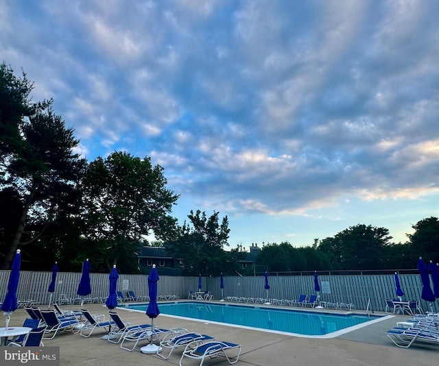 pool featuring a patio area and fence