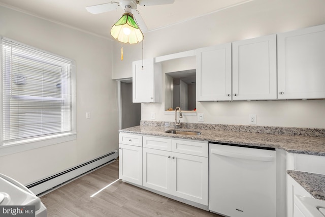 kitchen with light wood-type flooring, baseboard heating, white dishwasher, white cabinets, and a sink