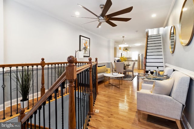 living room with recessed lighting, baseboards, light wood-style floors, and a ceiling fan