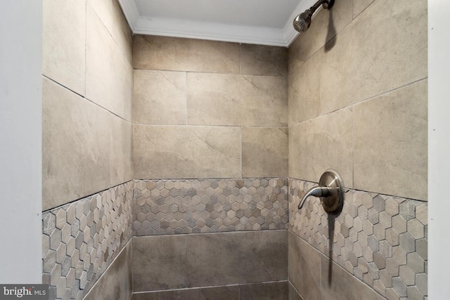 interior details with tiled shower and ornamental molding