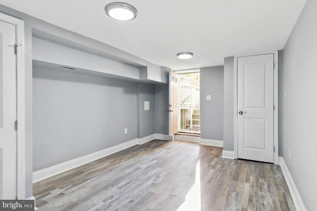 interior space featuring baseboards and wood finished floors