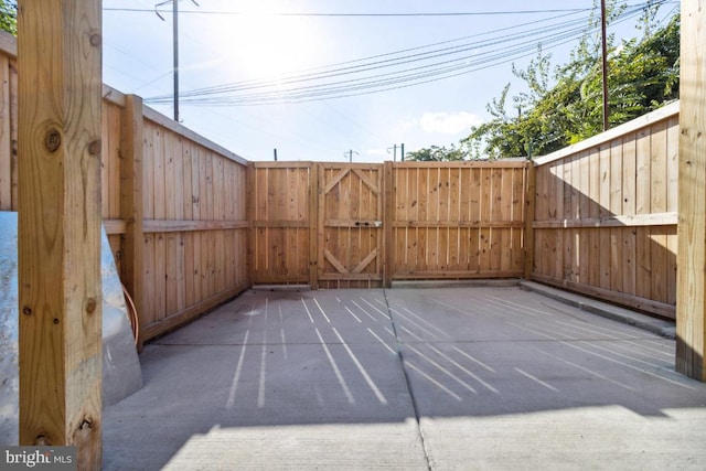 view of patio featuring fence and a gate