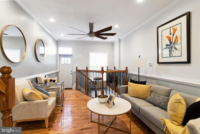 living room featuring recessed lighting, light wood-type flooring, ceiling fan, and crown molding