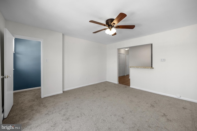 empty room with baseboards, carpet, and ceiling fan