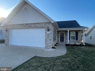 ranch-style home featuring a garage, stone siding, a front lawn, and driveway