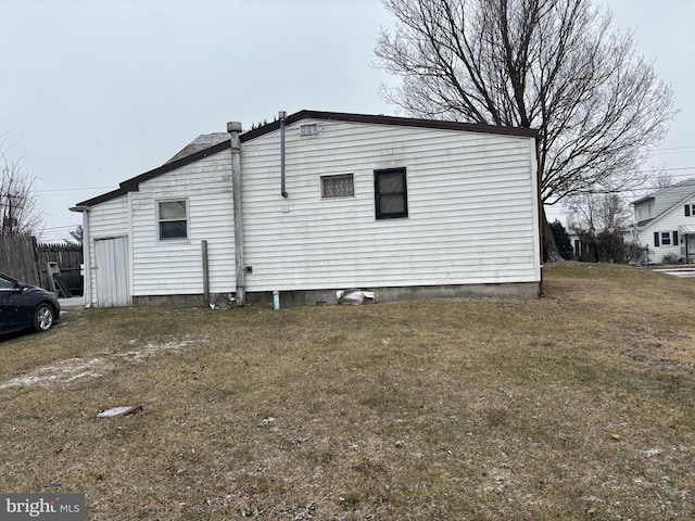 view of side of property with a yard