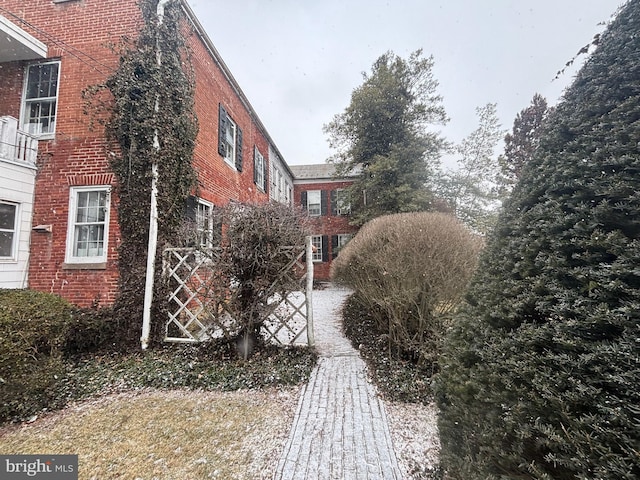 view of side of property featuring brick siding