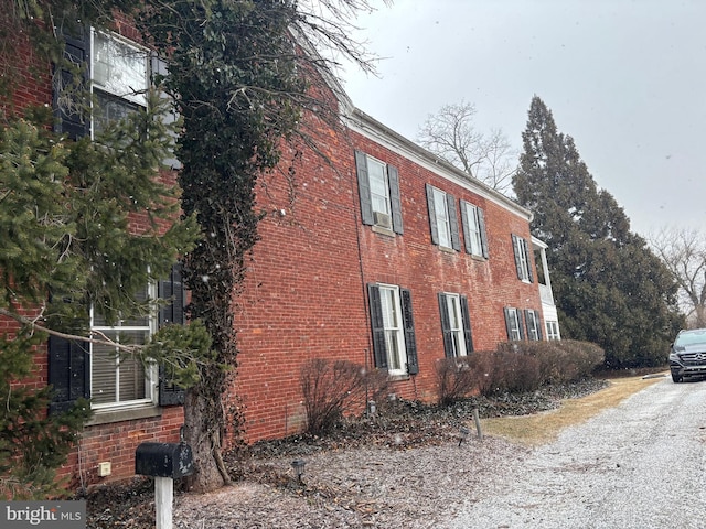 view of side of property with brick siding