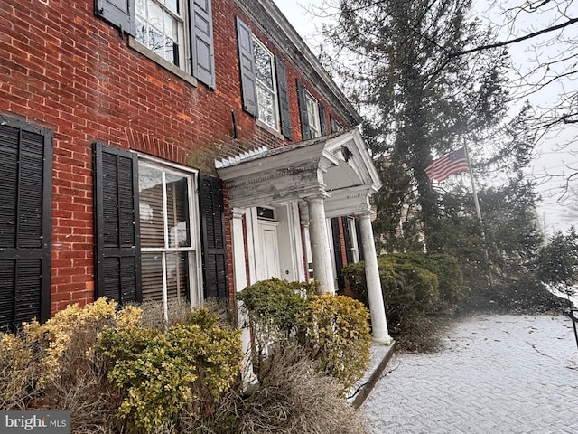 property entrance featuring brick siding