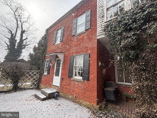 view of side of property featuring brick siding