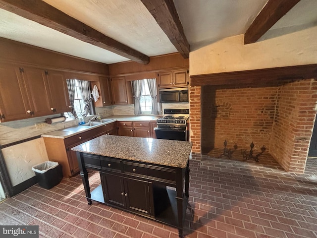 kitchen with stove, brick floor, black microwave, and a kitchen island