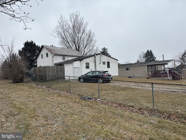 exterior space featuring a front yard and fence