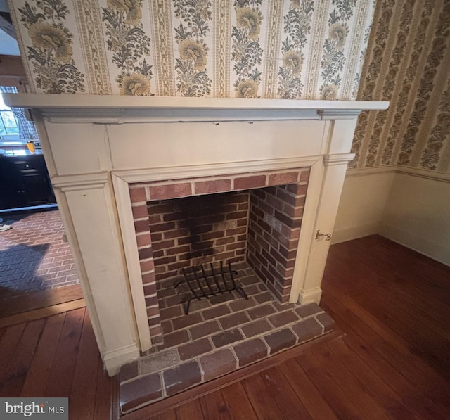 interior details featuring wood finished floors and wallpapered walls