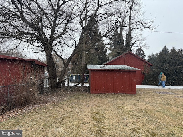 exterior space featuring a storage unit and an outbuilding