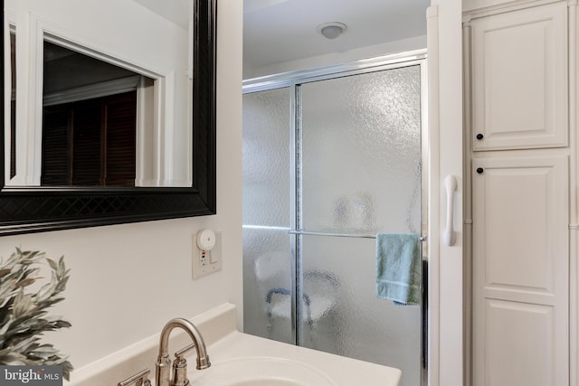 full bath with vanity and a stall shower