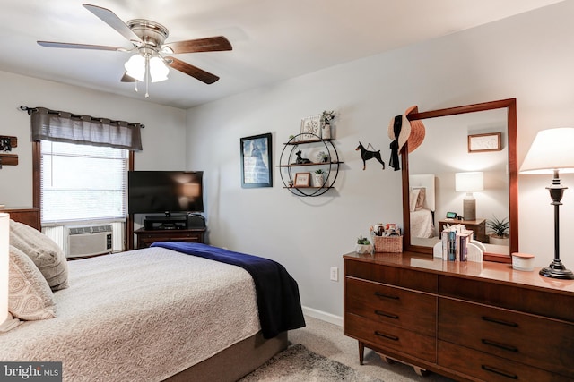 bedroom featuring cooling unit, a ceiling fan, baseboards, and carpet floors