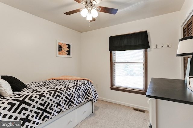 bedroom with ceiling fan, light colored carpet, visible vents, and baseboards