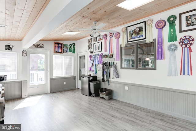 interior space with a wainscoted wall, a ceiling fan, wood finished floors, wood ceiling, and vaulted ceiling