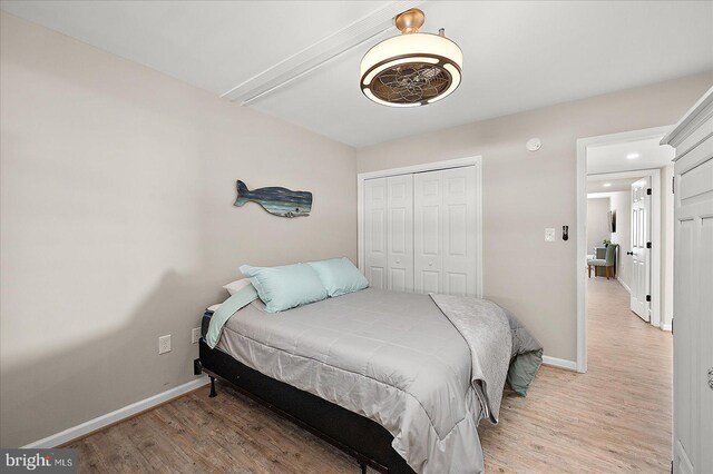 2901 Atlantic Ave Unit 101The, Towers, Ocean City, MD 21842 - bedroom featuring a closet, baseboards, and light wood finished floors