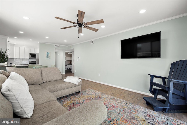 2901 Atlantic Ave Unit 101The, Towers, Ocean City, MD 21842 - living area featuring crown molding, baseboards, visible vents, a ceiling fan, and wood finished floors