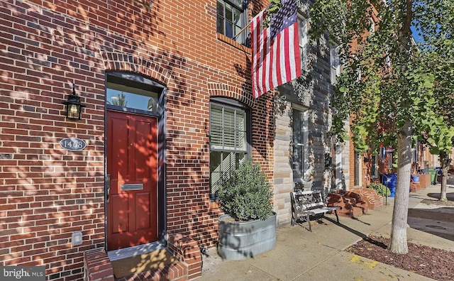 property entrance with brick siding