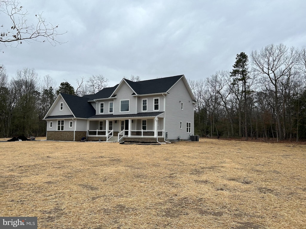 view of front of property featuring covered porch and central AC