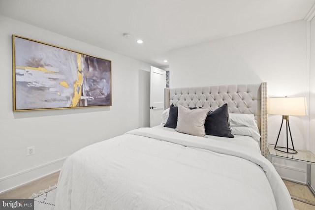 bedroom with light wood finished floors, recessed lighting, and baseboards