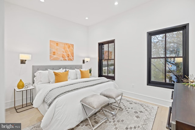 bedroom with recessed lighting, baseboards, and light wood-style floors