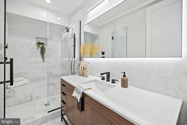 full bathroom with a marble finish shower, recessed lighting, vanity, and marble finish floor