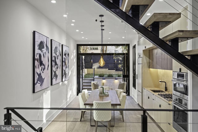 dining space with recessed lighting and light wood finished floors