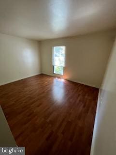 unfurnished room with wood finished floors