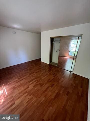 unfurnished bedroom featuring wood finished floors and a closet