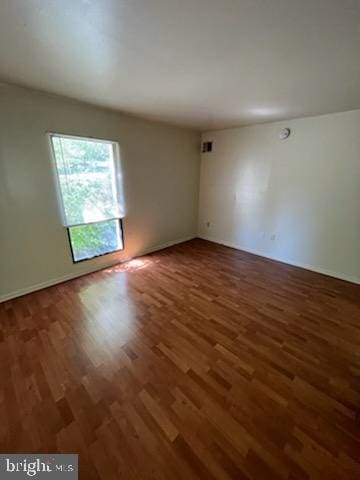 unfurnished room with wood finished floors