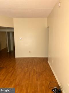 spare room featuring wood finished floors