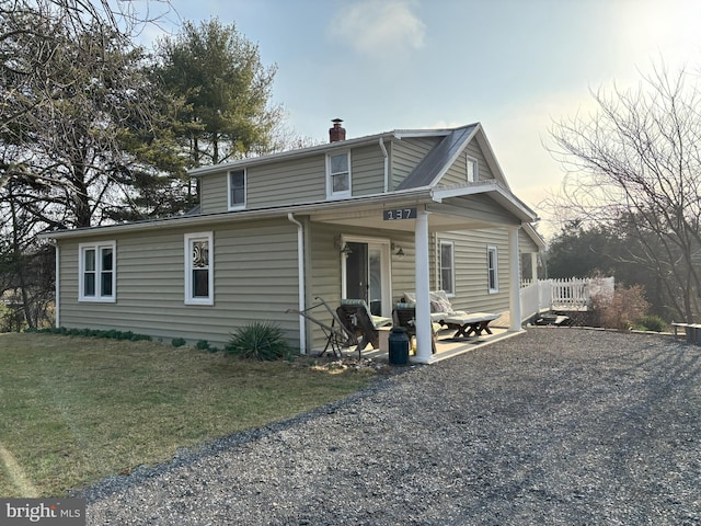 view of front of home featuring a front lawn, a chimney, and fence