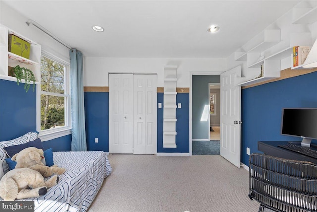 carpeted bedroom with baseboards, recessed lighting, and a closet