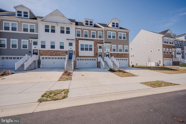 35416 Wright Way, Millsboro, DE 19966 - townhome / multi-family property featuring stone siding, an attached garage, driveway, and stairs
